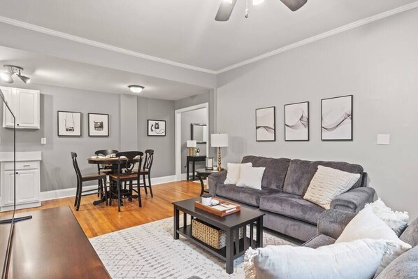 Open floor plan with living room adjoining dining area and kitchen