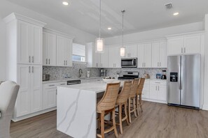Well appointed open concept kitchen and dining area with seating for 12