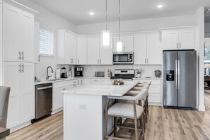 Well appointed open concept kitchen and dining area with seating for 12