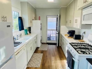 Kitchen with full appliances, washer and dryer, and coffee maker. 