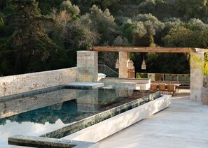 Relax in the Greek sunshine next to the swimming pool.  
