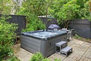 private courtyard with hot tub and small dining area