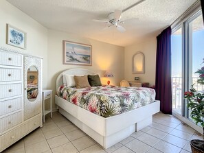 Elegant decor with a cozy queen bed and private balcony access.