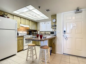 Fully equipped kitchen with a breakfast bar and ample storage space.