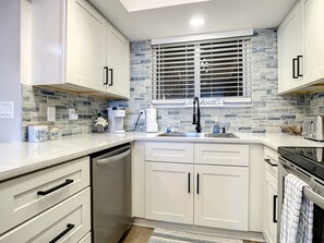 Elegant kitchen with modern cabinetry, subway tile backsplash, and stainless steel fixtures.