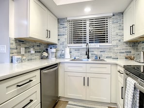 Elegant kitchen with modern cabinetry, subway tile backsplash, and stainless steel fixtures.