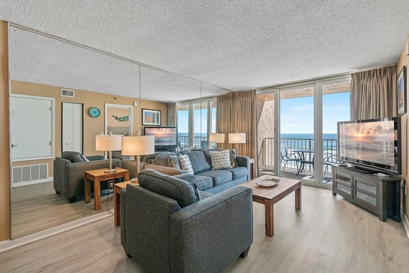 Cozy seating area with panoramic balcony views, modern decor, and abundant natural light.