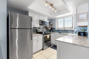 Cook in style with premium stainless-steel appliances paired with a striking mosaic backsplash.