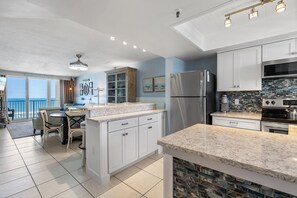 Seamlessly connect cooking and relaxation in this open-plan kitchen featuring ocean views and modern appliances.