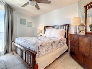 Peaceful bedroom with a cozy bed and direct access to the balcony overlooking the ocean.