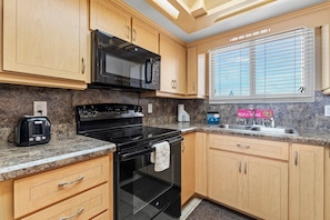 Modern kitchen with plenty of storage, ideal for preparing meals with ease.
