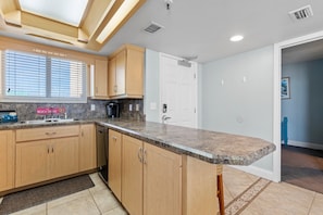 Enjoy cooking in a spacious kitchen featuring modern amenities and ample counter space.