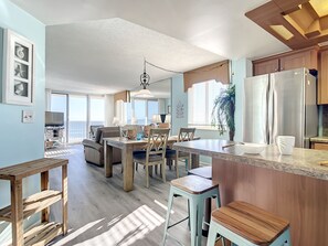 Bright, spacious layout with a cozy breakfast bar, dining area, and ocean-facing living room, perfect for relaxing and entertaining by the sea.