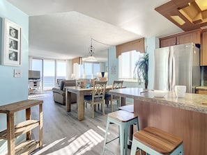 Bright, spacious layout with a cozy breakfast bar, dining area, and ocean-facing living room, perfect for relaxing and entertaining by the sea.
