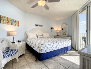 King bed with ceiling fan above.