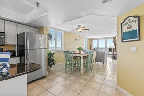 Enjoy cooking in a modern kitchen with stainless steel appliances, while the adjacent dining area offers ocean views. The open-concept layout connects seamlessly with the living room, creating a welcoming space for relaxing and dining.