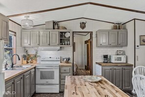 Charming kitchen with butcher block countertops.