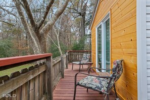 Front porch with a beautiful view of Spanish Moss in the trees.