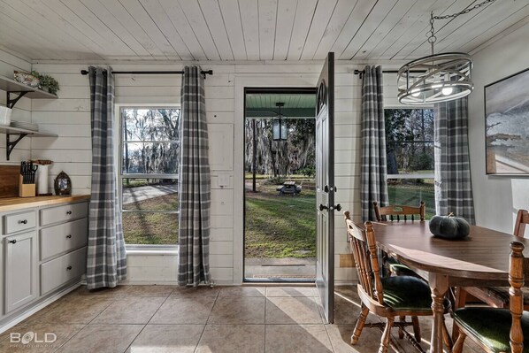 Adorable cottage kitchen with flannel curtains.