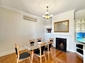 DIning are with ornamental fireplace & split system heater/air conditioner