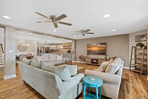 Family Room with many seating options and large TV.