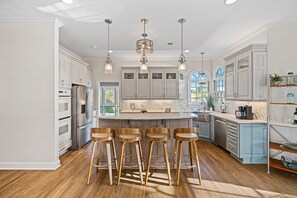 Fully stocked kitchen with island seating for 4.
