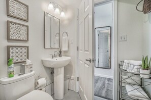 Unwind in our serene bathroom, featuring a sleek design and essential amenities that will leave you feeling refreshed and rejuvenated.