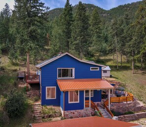 Tucked into the hillside, this vibrant mountain retreat offers a peaceful forest setting and scenic views from every angle.


