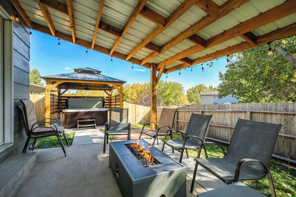 Welcome to Hearth Haven! The cozy living space, coupled with a spacious backyard featuring a firepit, invites relaxation and outdoor activities.
