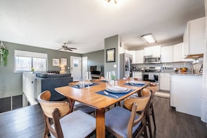 Open-concept dining area with seating for six, steps from the fully stocked kitchen and cozy living room.

