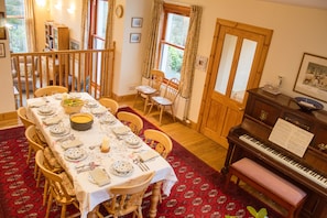 Dining table and piano at Carriden