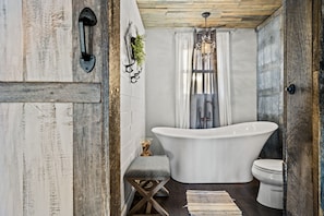 Elegant soaker tub is located in the bathroom.