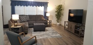 Family room with sectional couch and TV.  Lots of space to relax.