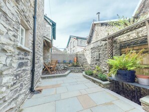 Private courtyard with outdoor dining area which catches the evening sun