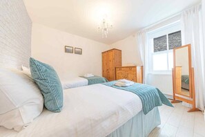 Twin bedroom with wardrobe and dresser