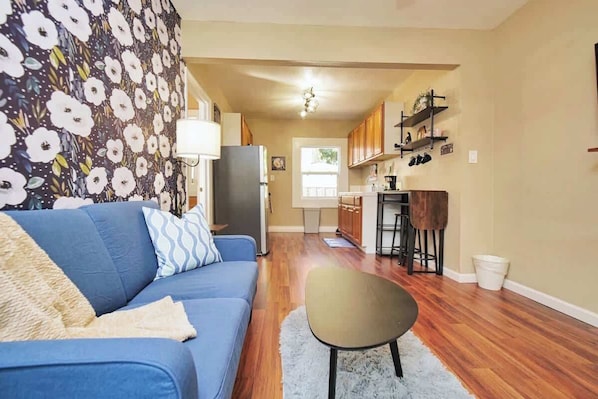 An open floor plan with the living room seamlessly leading into the dining area and kitchen for a spacious and interconnected layout.
