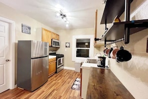 OOur kitchen, featuring a cook station on one side and a washing station on the other. The new, modern lights provide ample illumination from all directions, ensuring a well-lit and functional space.