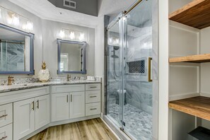 Master Bath Features a Generously Sized Vanity with Double Sinks and a Tiled Walk-In Shower