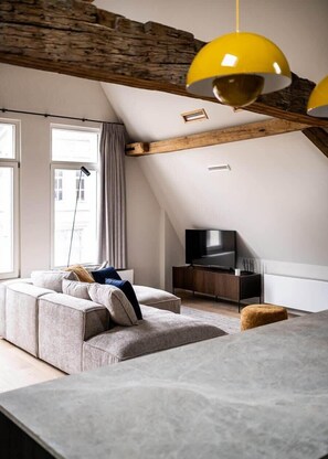 Elegant living space with exposed wooden beams and high ceilings