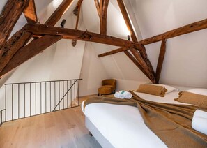 Enchanting mezzanine bedroom with rustic wooden beams