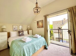 Master front facing king-sized bedroom- balcony, ensuite, wardrobe & soft linens