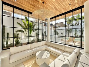 White sunken lounge with a poolside view