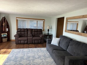 Living room has a pull-out sofa and recliners.
