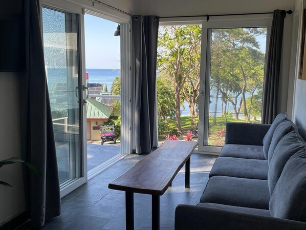 Living and Kitchen area with view to the Sea and Garden