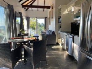 Living and Kitchen area with view to the Sea and Garden