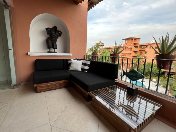 Veranda with pool and garden view.
