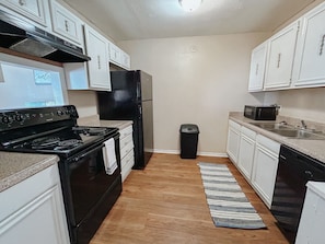 Kitchen fully stocked with daily cooking essentials and dishwasher