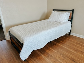 Comfortable bedroom with Twin XL bed and ample space for relaxation.