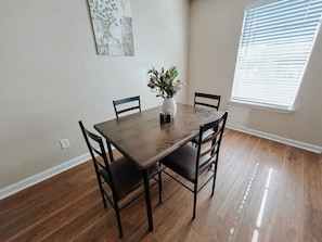 Simple dining area with seating for four.