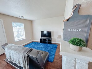 The living room has a futon couch, giving you plenty of space to relax.